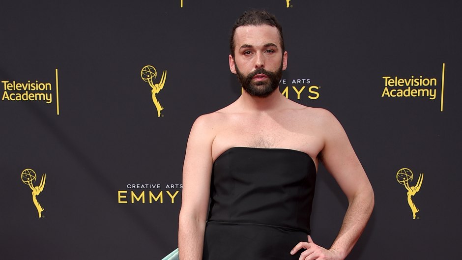 queer eye star jonathan van ness wears a black strapless mini dress with large teal bow accent on the 2019 Creative Arts Emmys red carpet queer eye jonathan van ness hiv positive