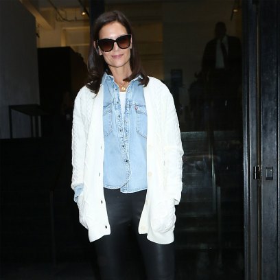 katie holmes wearing a white tee under a blue denim button down shirt under a white sweater with black leather pants and black high heeled boots at the Elie Tahari Spring 2020 Runway Show katie holmes attends elie tahari spring 2020 runway show at nyfw 2019