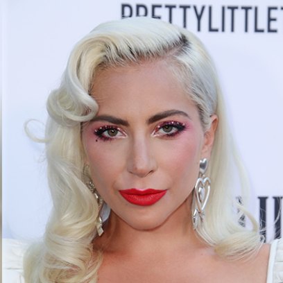 lady gaga wears her blonde hair in vintage old hollywood curls and her makeup look featured a red lip and she accessorized with diamond earrings at the 2019 daily front row fashion awards lady gaga and boyfriend daniel horton go on a date to a cure concert