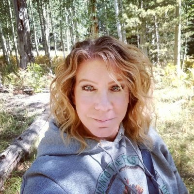 meri brown selfie in the woods wearing a hoodie