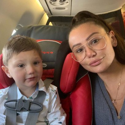 JWoww Wearing a Gray Shirt on a Plane With Son Greyson
