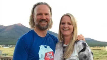 christine brown and husband kody smiling with mountains behind them