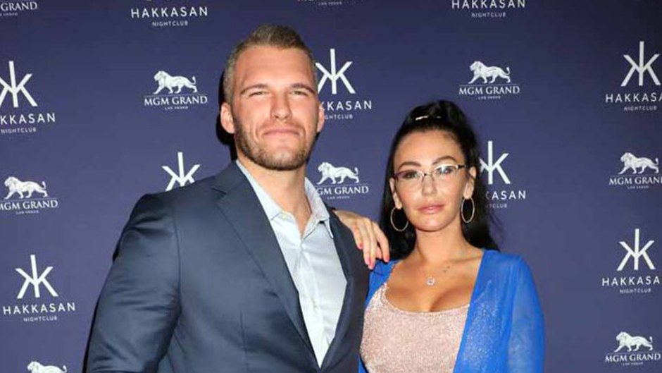 jersey shore star jwoww wears a nude two-piece crop top and skirt with a blue sweater over it; zack clayton carpinello wears a light blue button down shirt underneath a navy blue blazer; jwoww and zack clayton carpinello reunite after split