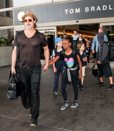 Brad Pitt Wearing Hat and Sunglasses Waklking With Kids