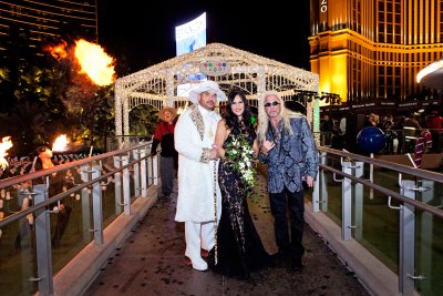 duane dog chapman posed with the bride and groom at their las vegas wedding cereomony