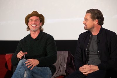 Brad Pitt Wearing a Hat With Leonardo DiCaprio on Stage