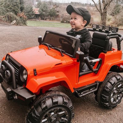 jackson roloff grinning in a toy car