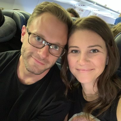 adam and danielle busby sitting on a plane