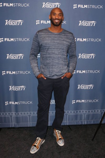 Kobe Bryant Wearing a Blue Shirt With Jeans