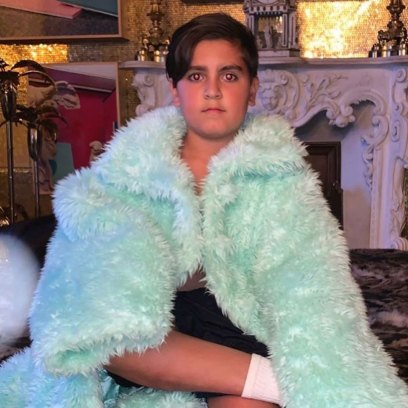 Mason Disick Sits Seriously Wrapped in Turquoise Coat
