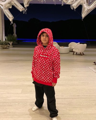 Mason Disick Stands in a Red Hoodie and Black Sweats