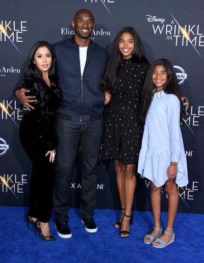 Kobe Bryan Wears Blue Suit Smiling With Wife Vanessa in Black Dress and Daughters Gianna and Natalia