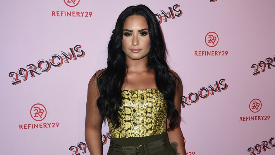 Demi Lovato Smiles in High Waisted Pants and Snake Skin Top