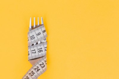 Diet and Weight Loss Fork Photo Yellow Background