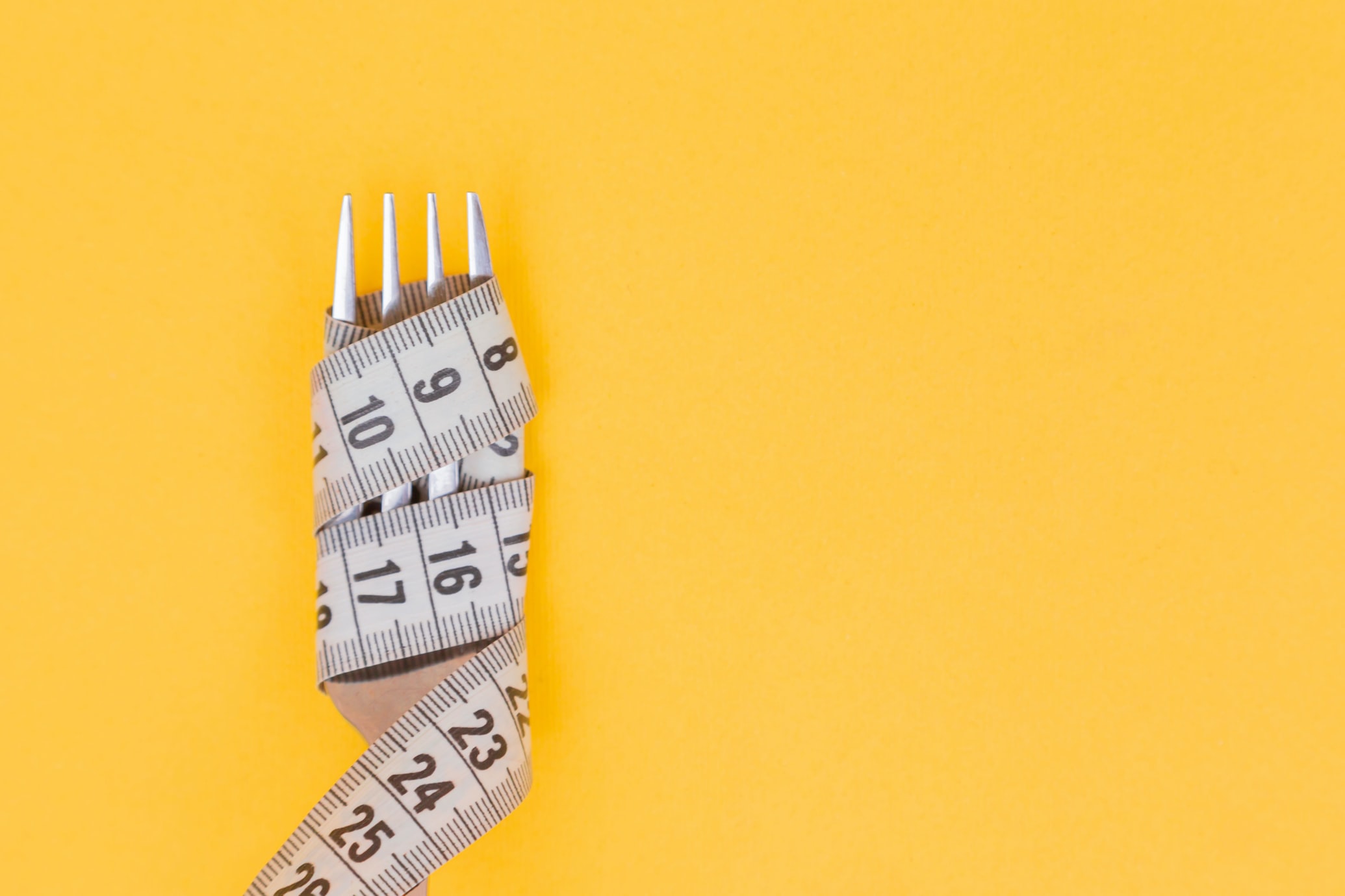 Diet and Weight Loss Fork Photo Yellow Background
