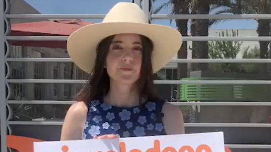 Alexa Nikolas holding up a sign that reads Nickelodeon didn't protect me