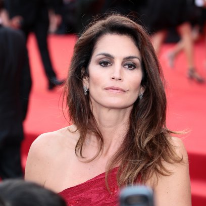 Cindy Crawford wearing a red dress on a red carpet