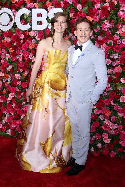 Ethan Slater wearing a pastel tuxedo and his wife, Lilly Jay, wearing a floral dress at the Tony Awards in 2018