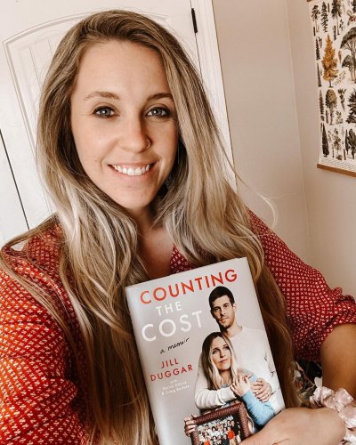 Jill Duggar holding a copy of her memoir, 'Counting the Cost'