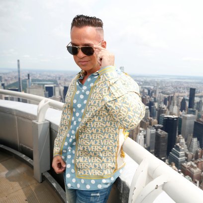 Jersey Shore star Mike Sorrentino wears sunglasses and a button down shirt on the top of the Empire State Building