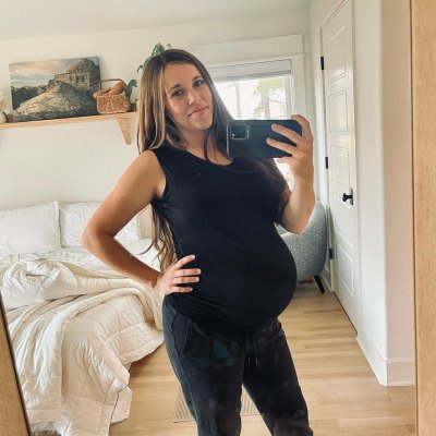 Jessa Duggar shows off her bump for baby no. 5 in a black tank top and leggings.
