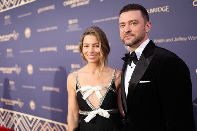 Justin Timberlake wearing a tuxedo next to Jessica Biel in a black gown with bow accents