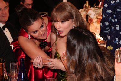 Selena Gomez holds Taylor Swift as Taylor looks shocked at the 2024 Golden Globes