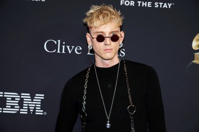 Machine Gun Kelly wears all black and some sunglasses at the 2024 Grammys.