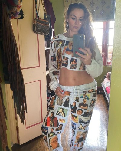 Drea de Matteo poses for a selfie while wearing a sweatsuit with images from 'The Sopranos' on it