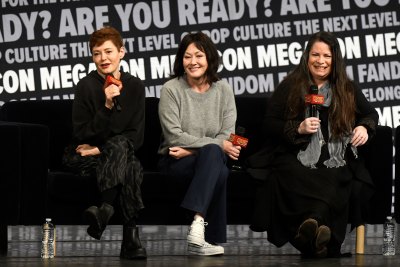 Rose McGowan, Shannen Doherty, and Holly Marie Combs laugh on stage at MegaCon 2024.