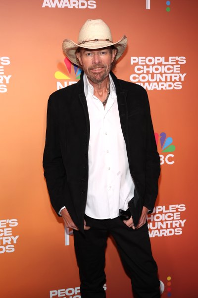 Toby Keith wears a black jacket, white button down and cowboy hat.