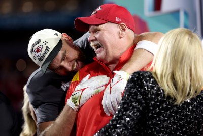 Travis Kelce hugs Andy Reid after Super Bowl LVII win.